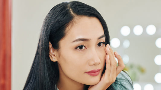 Woman applying under eye serum